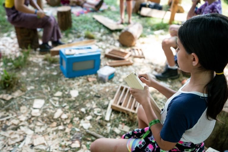 child carving wood