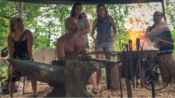 Neo Pre/Post Apocalyptic Blacksmithing: Intro to Blacksmithing w/ Tod Kershaw 4 people learning how to blackmith outside on a homemade forge