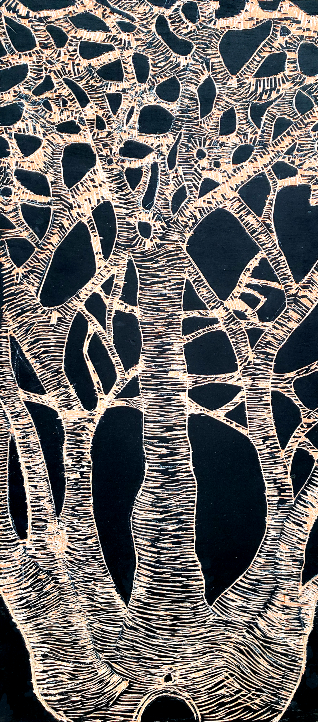 little person sitting at base of trees whose branches are anastomosing together